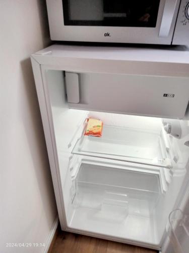 a refrigerator with its door open with a microwave at Antwerpen OLIVIA Apartments in Antwerp