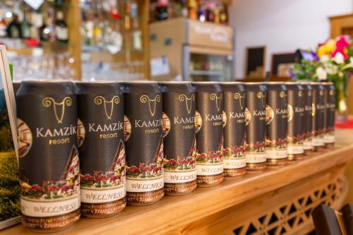a row of coffee cups on a shelf in a store at Wellness Resort Kamzík in Ždiar