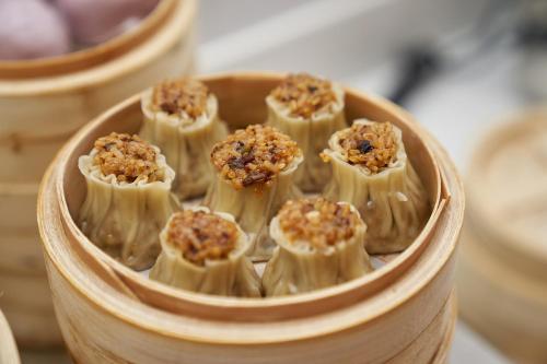 a wooden bowl of food with nuts on top at 珠海海之珠丨Global Romantic Pearl酒店-拱北口岸珠海站店 in Zhuhai