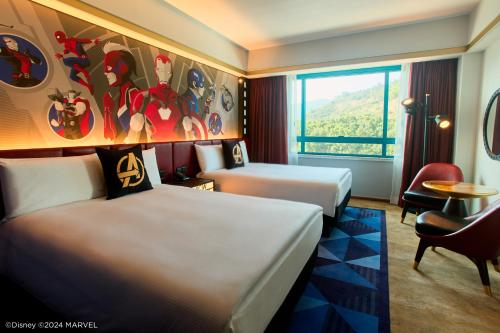 a hotel room with two beds and a window at Disney's Hollywood Hotel in Hong Kong