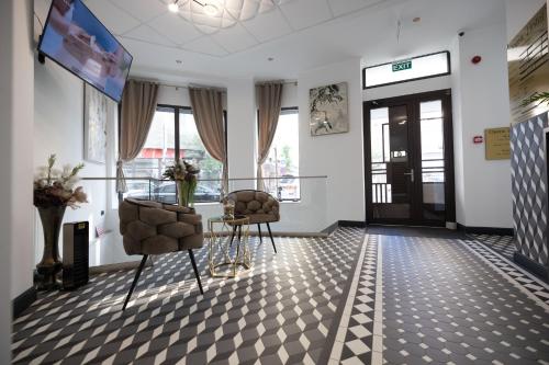 a waiting room with two chairs and a tv at Opera Hotel in Timişoara