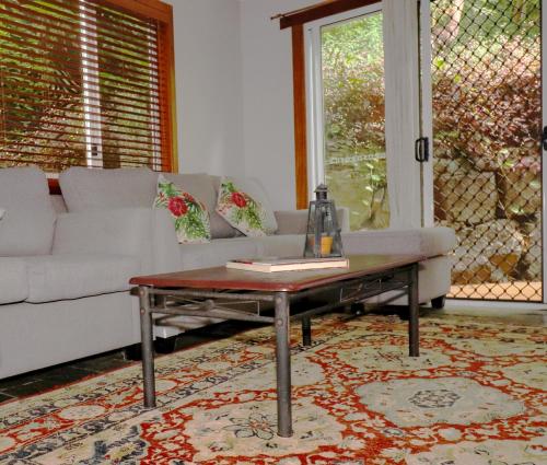 a living room with a couch and a coffee table at Whitsundays BNB Retreat in Airlie Beach