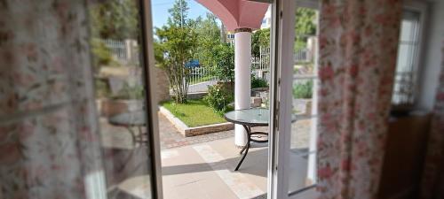 a view of a patio through a glass door at Valloris Apartments in Hévíz