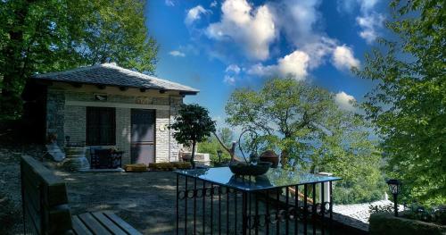 a small house with a table in front of it at The Mushroom Cottage in Anilio Pelion