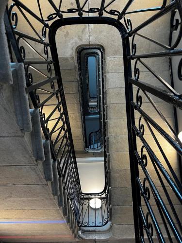 a view of a stairway through a iron gate at Aloft Hotel, By Marriott in Dijon