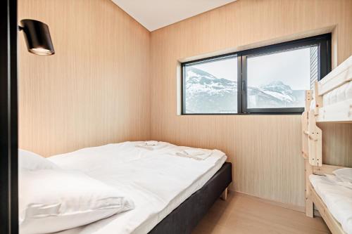a small room with two beds and a window at Northern Cabin Retreat in Lyngværet