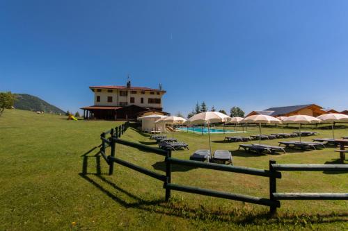 a field with a group of chairs and tents at Sport Hotel Prodongo in Brallo di Pregola