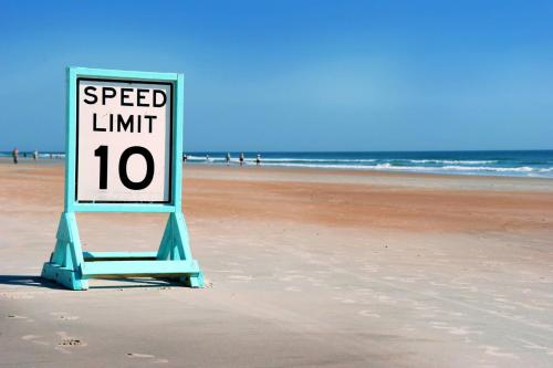 a speed limit sign sitting on a beach at 3652 Francis Street in Port Orange