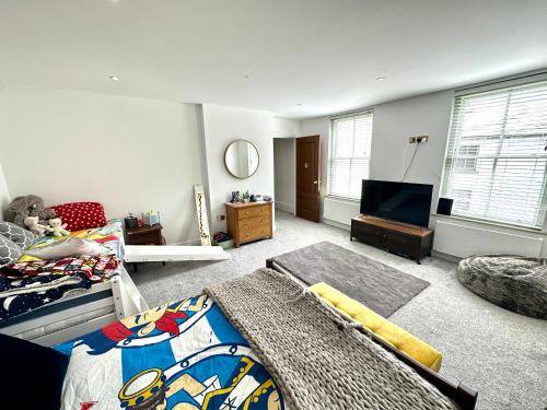 a bedroom with a bed and a flat screen tv at 5 Bed Luxury House with Swimming pool in Chepstow