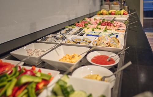 a buffet line with many different types of food at AKZENT Hotel Aufkirchen in Aufkirchen