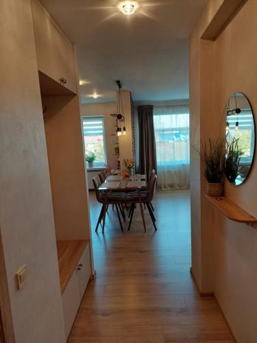 a living room with a table and a dining room at trendy in Ventspils