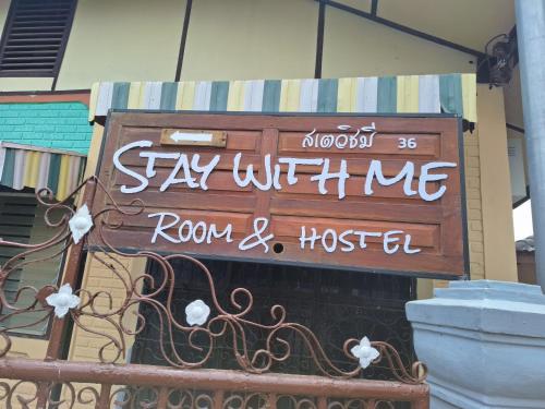 a sign on the side of a building at Stay with me in Pai in Pai