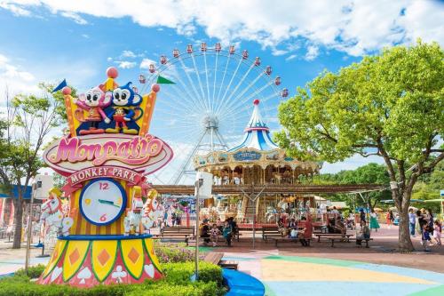 a carnival with a ferris wheel and a clock at Inuyama City Hotel in Inuyama