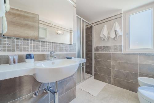 a bathroom with a sink and a toilet at Villa Mia in Capoliveri