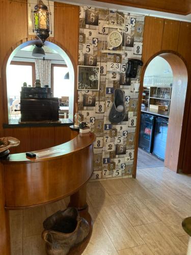 a room with a table and a wall covered in pictures at Gasthof Walhalja in Schmallenberg