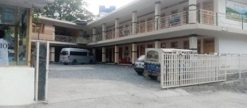 a white van parked in front of a building at Hotel Lucky Inn in Nārān