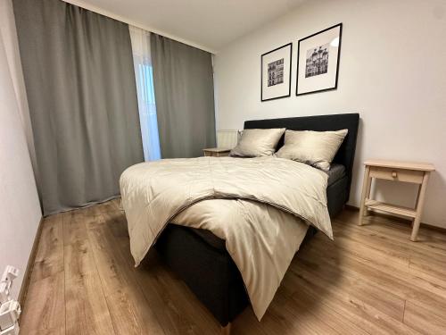 a bedroom with a large bed and a wooden floor at IOS Garden in Prague