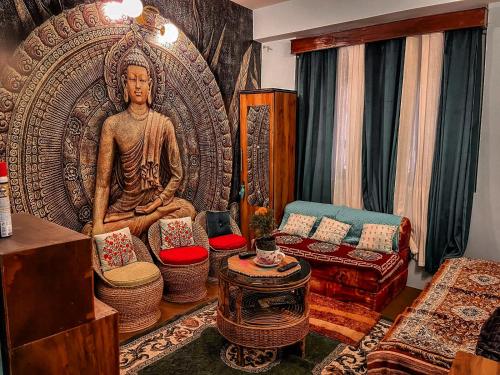 a living room with a large statue of a man at StayCation Homestay in Gangtok