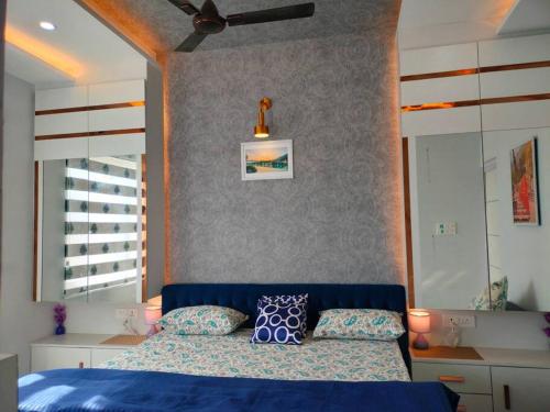a bedroom with a blue bed and a ceiling fan at Blue Heart Home by the Ganges - Cosy 1Bhk-Veerbhadra in Rishīkesh