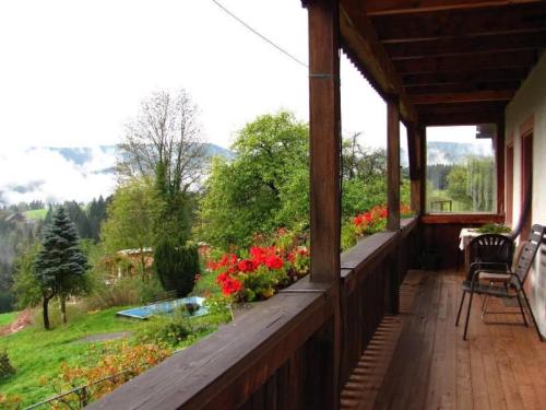 a porch of a house with flowers on it at Ferienhof Rohrbachhof in Schiltach
