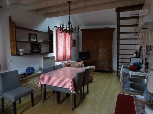 a dining room with a table and chairs at chez madame cigogne in Douzy