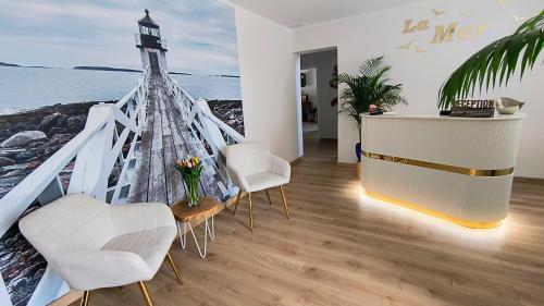 a room with a lighthouse painted on the wall at La Mer Pokoje i Apartamenty in Władysławowo