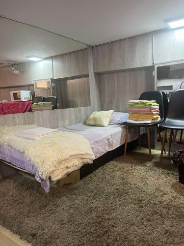 two beds in a room with a table and chairs at Good choise in Chişinău