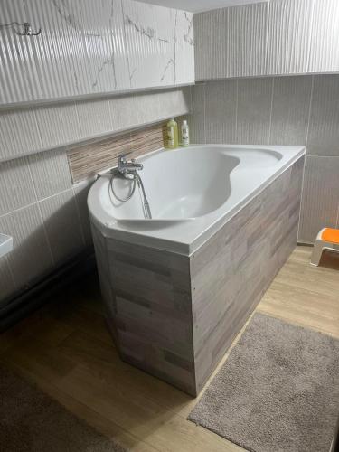 a bath tub with a faucet in a bathroom at Good choise in Chişinău