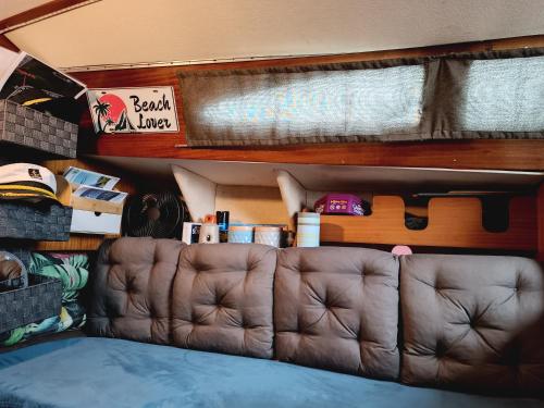 a leather couch in the back of a trailer at Nuit insolite à bord d'un voilier et sortie à la Voile au cœur de la ville de Sète in Sète