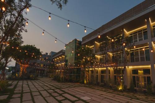 an empty courtyard with string lights in front of a building at PAPO'A Harbor Hotel in Kaohsiung