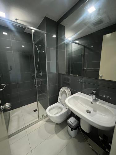 a bathroom with a shower and a toilet and a sink at Acqua Private Residences - Livingstone Tower (Makati - Mandaluyong) in Manila