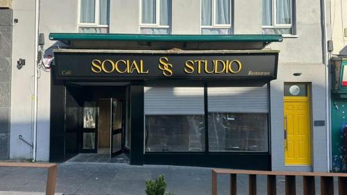 a store with a sign that reads social st studio at No.5 in Derry Londonderry