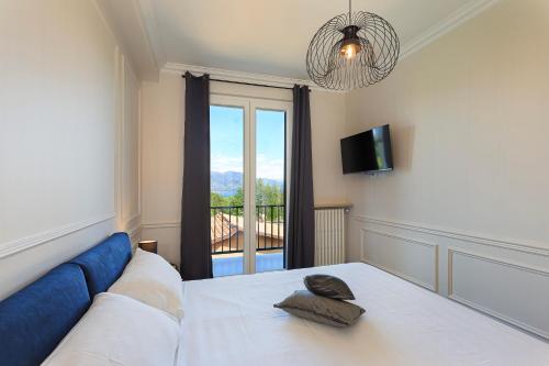 Un dormitorio con una cama con vista a un balcón. en PepeNero, en Stresa