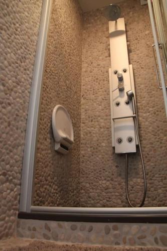 a shower in a bathroom with a shower at Boutique appartment with vue on sea and dunes in Koksijde