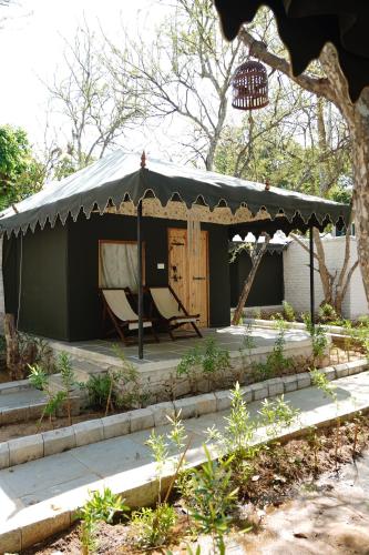 a gazebo with a chair and a table at Heli Pushkar in Pushkar