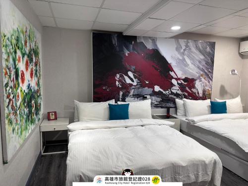 a bedroom with two beds and a painting on the wall at ArtHome藝宿家客棧 in Kaohsiung
