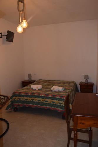 a bedroom with a bed with two towels on it at La Masseria Hotel Ristorante Centro Benessere in Cocumola