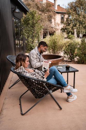 a man and a woman sitting in a hammock at Hôtel Lilybloom in Le Havre