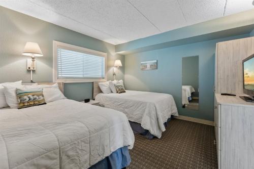 a hotel room with two beds and a flat screen tv at 9103 Atlantic Ave, Unit 415 in Wildwood Crest