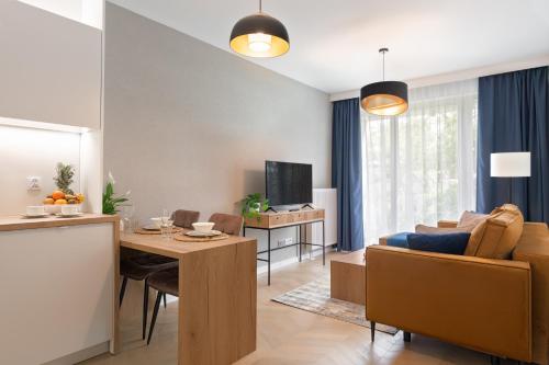 a living room with a table and a couch at Metropolis Old Town Apartments in Kraków