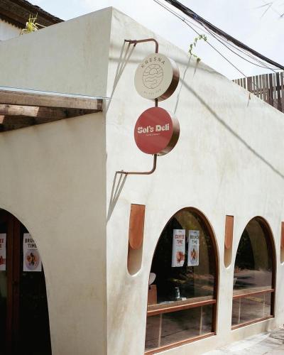 a sign for a sushi bar on the side of a building at Kresna By The Sea By Kresna Hospitality in Seminyak