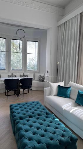 a living room with a large blue ottoman at Hotel Maestrale in Riccione