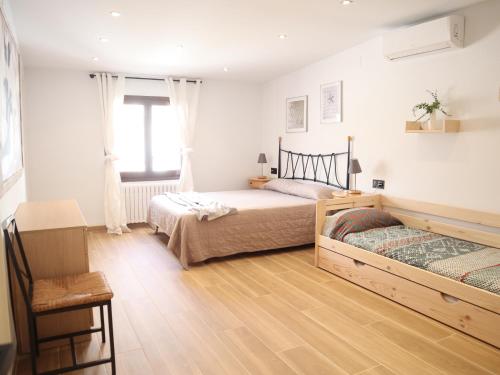 a bedroom with two beds and a window at Nina´s Paradise in L'Ampolla
