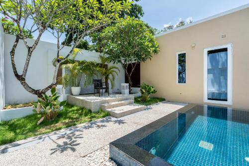 a swimming pool in the backyard of a villa at Sunshine Beach Villa Mai Khao in Mai Khao Beach