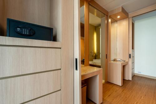 a bathroom with a door with a television on it at Sunshine Beach Villa Mai Khao in Mai Khao Beach