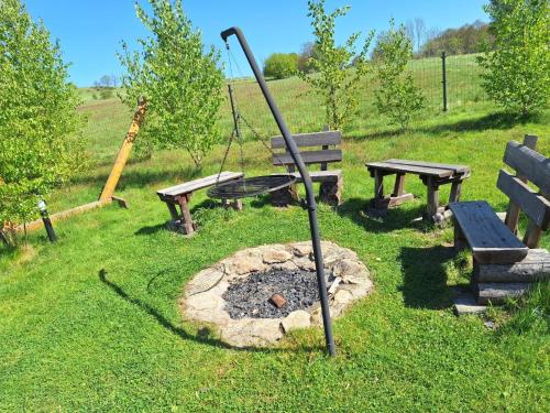 a park with a swing and picnic tables and a playground at Kameralne pole namiotowe, ZABIERZ SWÓJ NAMIOT, blisko Świeradów i zamek Czocha in Giebułtów