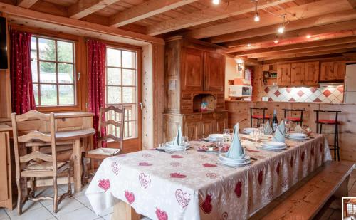 a dining room with a table in a kitchen at Chalet Les Liouès in Sollières-Sardières