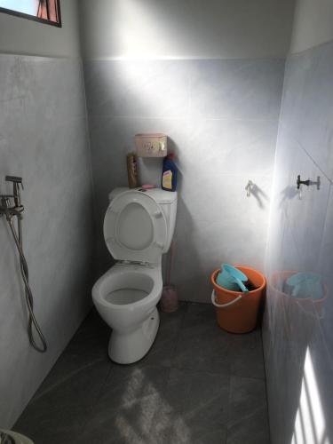 a bathroom with a white toilet in a stall at Homestay Siti 2 in Klang
