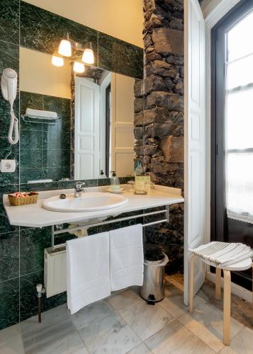 a bathroom with a sink and a stone wall at Mar Del Sueve in Colunga