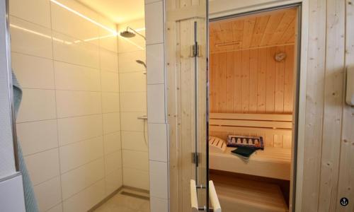a bathroom with a shower with a bench in it at Kapitänshaus 2 in Kellenhusen